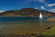 Tegernsee lake with white yacht in Alps