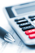 Photo: Tax calculator and pen Tax calculator and pen