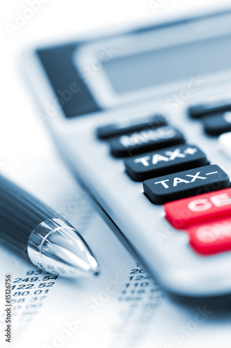Photo: Tax calculator and pen Tax calculator and pen