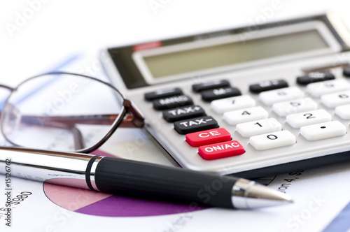 Photo: Tax calculator pen and glasses Tax calculator pen and glasses