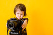 Foto: Baby girl holding photo camera Baby girl holding photo camera