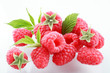 Raspberries with leaves on white
