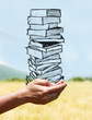 mains portant une pile de livres mains portant une pile de livres