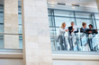 Team of colleagues discussing business by a glass railing