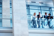 Group of colleagues discussing business by a glass railing