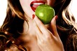 Woman eating a green apple