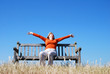 Ecstatic woman sitting on bench