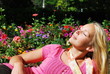 Woman enjoying the sun in a flower garden
