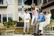 Family relaxing on patio together playing air guitar Family relaxing on patio together playing air guitar