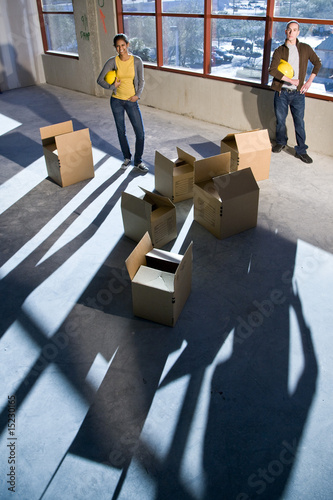 Photo: Multi-ethnic businesspeople preparing new office space Multi-ethnic businesspeople preparing new office space