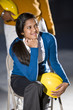 Closeup of young woman holding hard hat