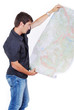 Man standing and looking at maps in his hands Man standing and looking at maps in his hands