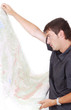 Man standing and looking at maps in his hands