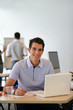 homme souriant en formation professionnelle devant un ordinateur