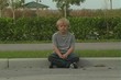 Boy at Roadside Curb
