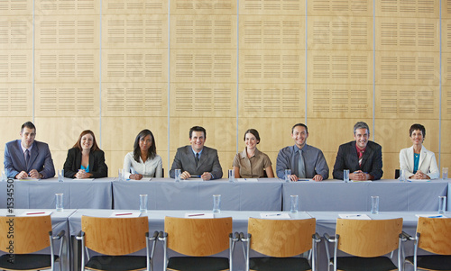 Photo: Businesspeople sitting at table smiling Businesspeople sitting at table smiling