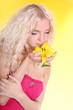 young blond woman with yellow lily flower