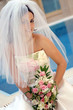 Smiling bride wearing veil