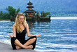 Girl meditating at the lake on Bali