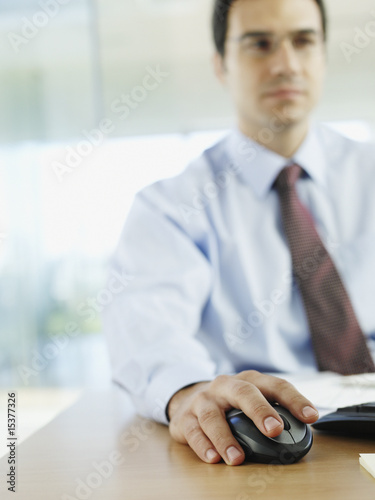 Photo: Man in office working on personal computer Man in office working on personal computer