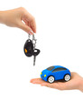 Hands with keys and toy car