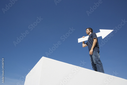 Photo: Man outdoors on wall with blank arrow Man outdoors on wall with blank arrow