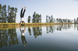 Man doing handstand on water