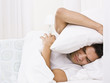 Photo: Tired Man Hiding His Head with Pillow Tired Man Hiding His Head with Pillow