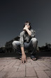 Photo: Man squatting on the street Man squatting on the street