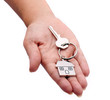 Photo: hand with chrome house key isolated handing over hand with chrome house key isolated handing over