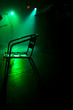 Chair on the stage in green backlight with a fiddler