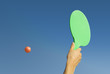 Moment of a game of rackets on the beach in summer..