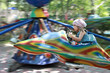 The girl on goes for a drive on an attraction