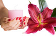 Beautiful hands with manicure, candle and lily