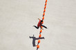 Man leaping over row of traffic cones