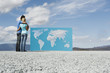 Man and woman looking at world map outdoors