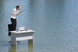 Businesswoman standing on a chair on water shouting into a telephone