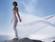 Woman with a sheer sheet with ocean backdrop
