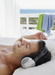 Man lying in bed wearing headphones