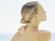 Woman looking serene with her hand behind her neck