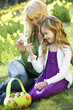 Mother and Daughter Looking at Toy Easter Bunny