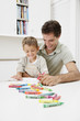 A father and son colouring together