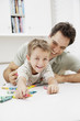 A father and son colouring together
