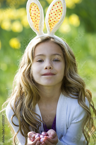 Photo: Young Girl Holding Easter Eggs Wearing Bunny Ears Young Girl Holding Easter Eggs Wearing Bunny Ears
