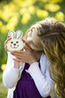 Young Girl Holding Chocolate Bunny Wearing Bunny Ears