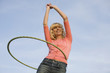 Young Woman With Hula Hoop Around Waist Smiling