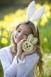 Young Girl Holding Chocolate Bunny Wearing Bunny Ears
