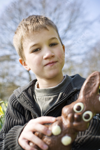 Photo: Portrait of Young Boy Holding Chocolate Easter Bunny Portrait of Young Boy Holding Chocolate Easter Bunny