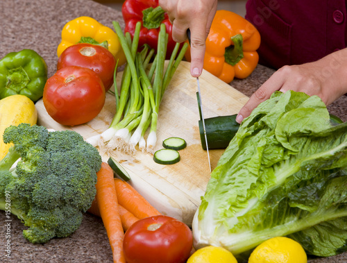 Photo: A woman cutting up fruits and vegetables A woman cutting up fruits and vegetables