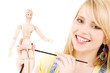 happy teenage girl with wooden model dummy